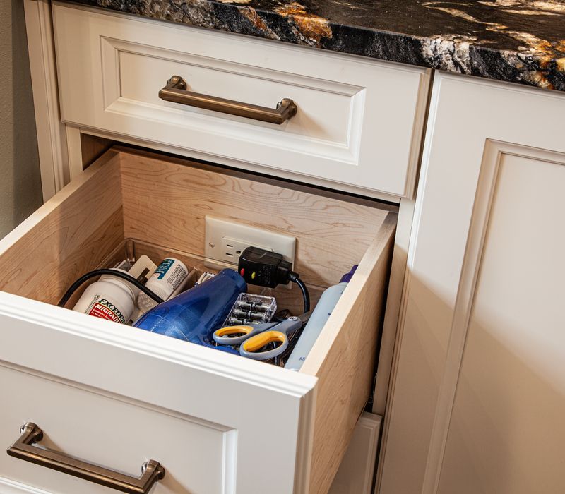 Bronze crosshatched mirror frames, herringbone wood look floor tile, and a vaulted ceiling add distinction to this two vanity bathroom.