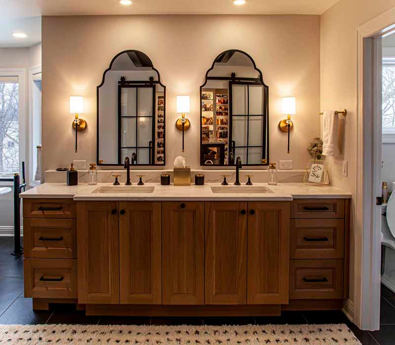 Elegance reigns supreme in this bathroom remodel that features an en suite, walk-in closet, walk-in shower, custom double vanity, private water closet, framed-glass barn doors, and a dazzling starburst chandelier.