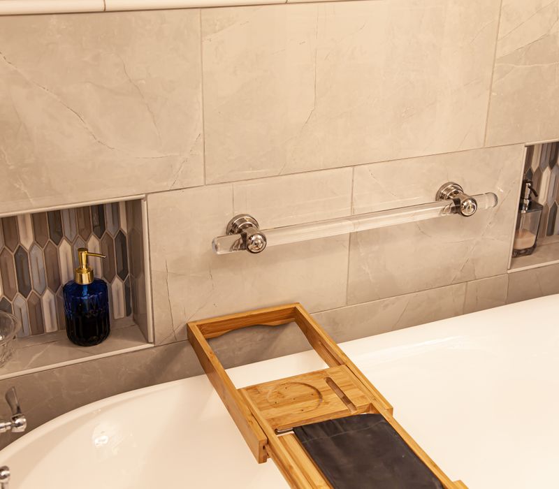 Wallpaper featuring monkeys posing on Venetian architecture, light blue cabinets, and elongated hexagon mosaic tiles add interest to this elegant bathroom with laundry machines and an attached walk-in closet.