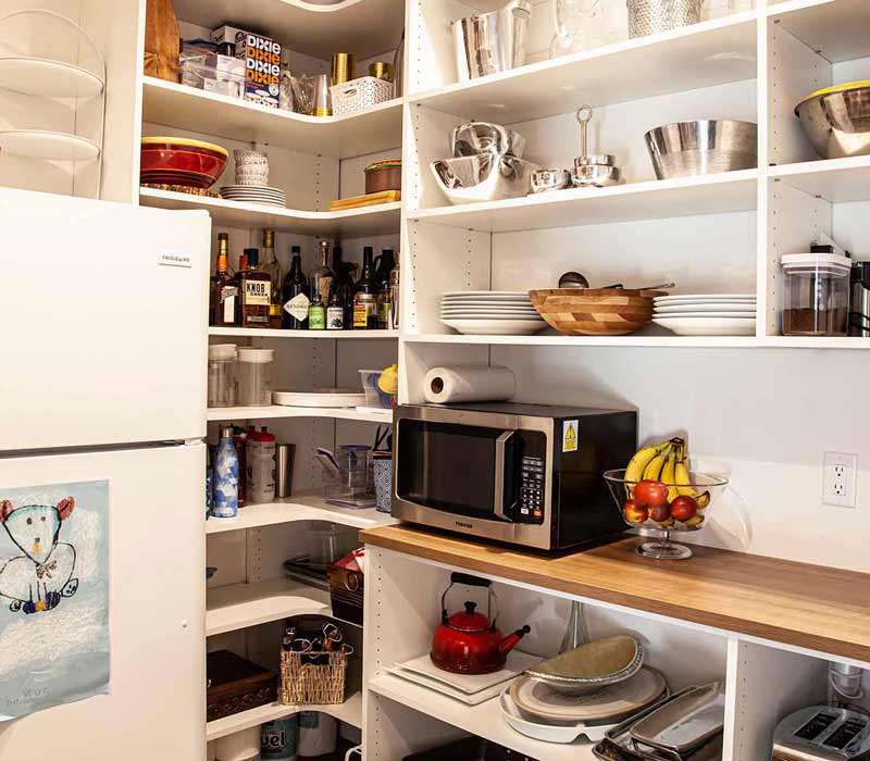 Concealed by what looks like tall cabinet doors, this full walk-in pantry frees up space in the kitchen and provides convenient storage for dry goods, perishables, and cookware alike.