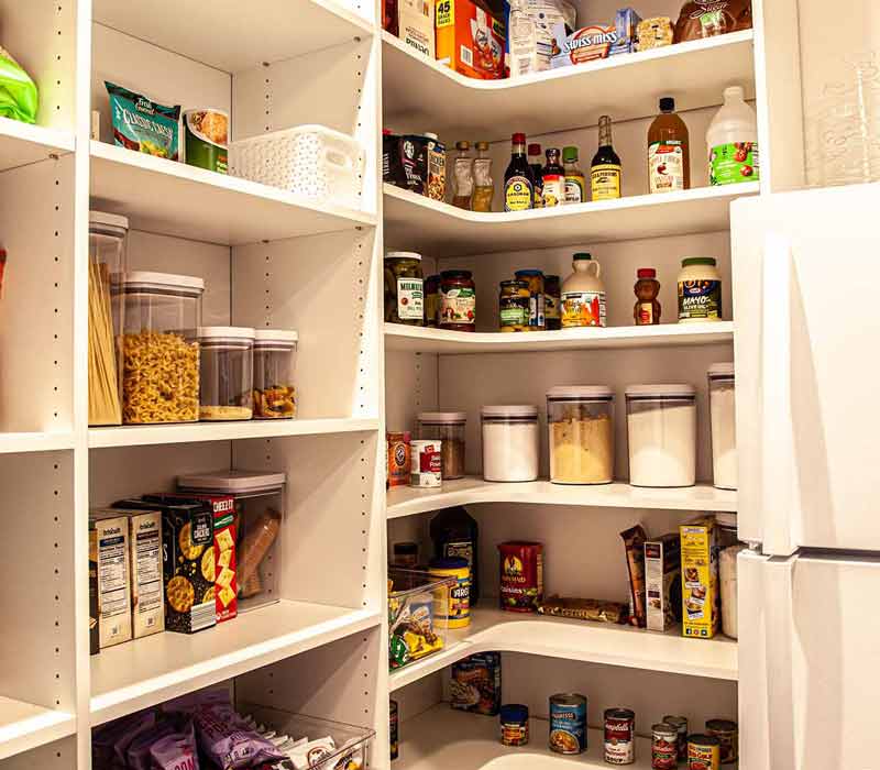 Concealed by what looks like tall cabinet doors, this full walk-in pantry frees up space in the kitchen and provides convenient storage for dry goods, perishables, and cookware alike.