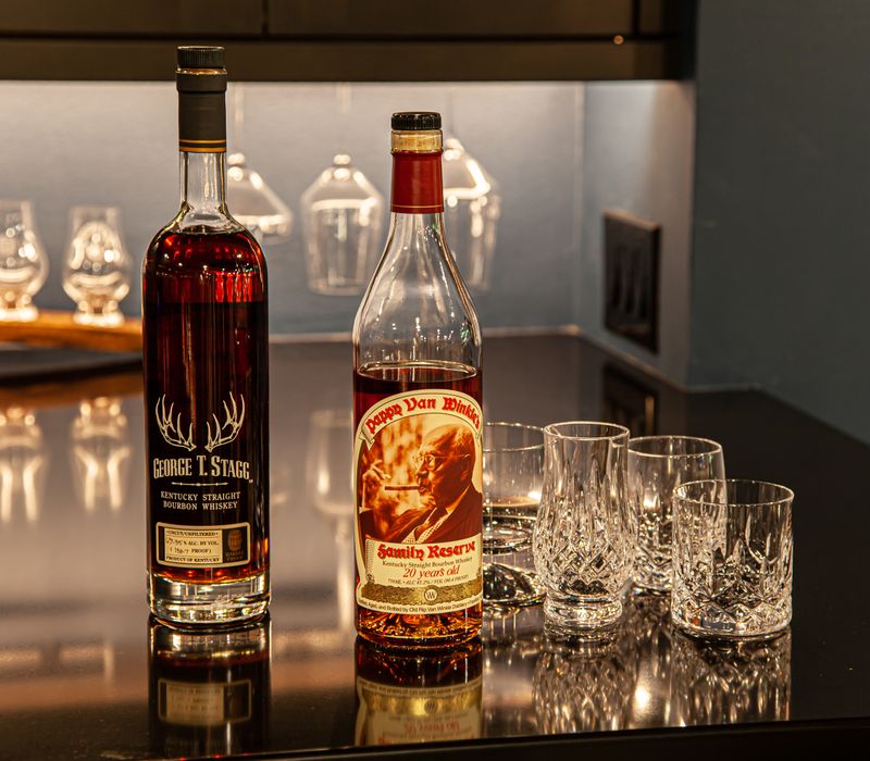 These dramatic lighted cabinets showcase an extensive liquor collection, while the bar provides a convenient spot to enjoy it, and the basement rec room a place to unwind.