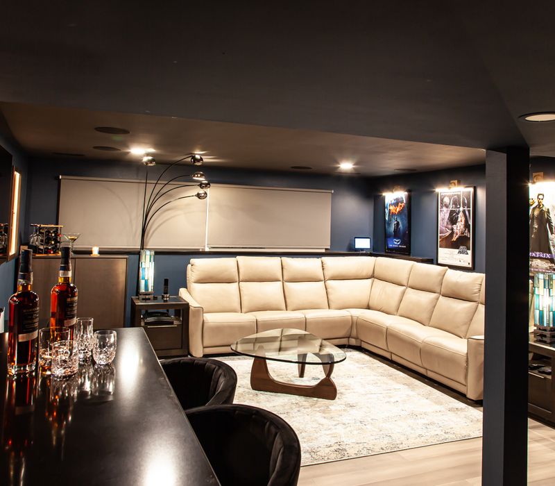 These dramatic lighted cabinets showcase an extensive liquor collection, while the bar provides a convenient spot to enjoy it, and the basement rec room a place to unwind.