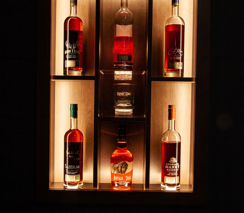These dramatic lighted cabinets showcase an extensive liquor collection, while the bar provides a convenient spot to enjoy it, and the basement rec room a place to unwind.