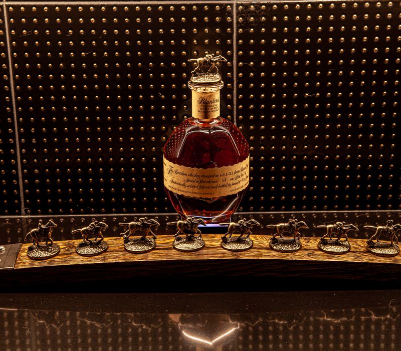 These dramatic lighted cabinets showcase an extensive liquor collection, while the bar provides a convenient spot to enjoy it, and the basement rec room a place to unwind.