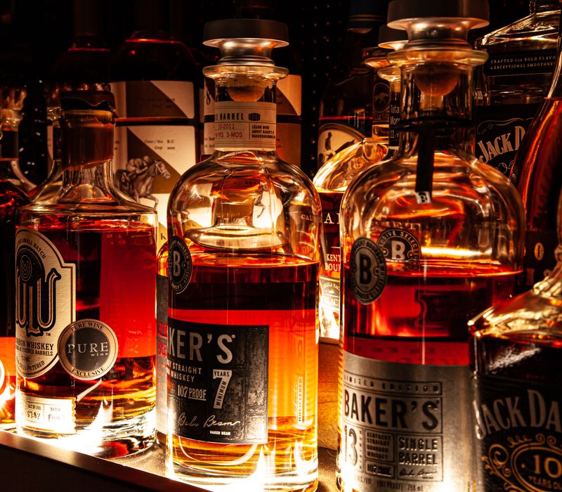 These dramatic lighted cabinets showcase an extensive liquor collection, while the bar provides a convenient spot to enjoy it, and the basement rec room a place to unwind.