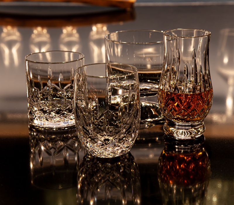 These dramatic lighted cabinets showcase an extensive liquor collection, while the bar provides a convenient spot to enjoy it, and the basement rec room a place to unwind.