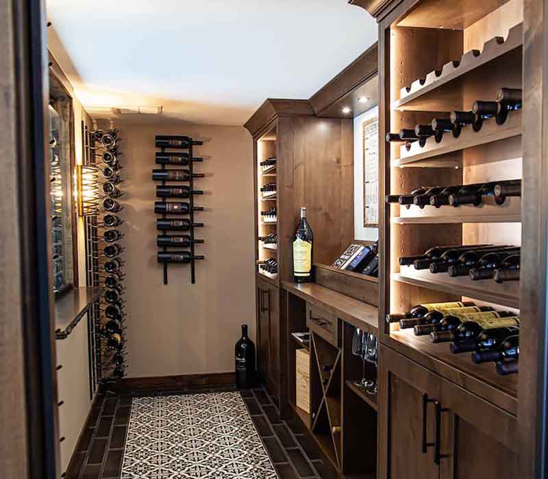 This wine cellar features a wine room with temperature and humidity control and custom storage and displays for up to 350 bottles. The adjoining wine tasting room provides space for the homeowners to gather, converse, and celebrate.