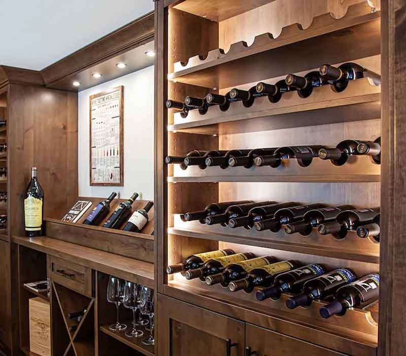 This wine cellar features a wine room with temperature and humidity control and custom storage and displays for up to 350 bottles. The adjoining wine tasting room provides space for the homeowners to gather, converse, and celebrate.