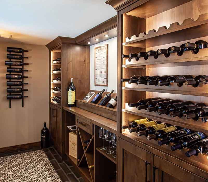 This wine cellar features a wine room with temperature and humidity control and custom storage and displays for up to 350 bottles. The adjoining wine tasting room provides space for the homeowners to gather, converse, and celebrate.