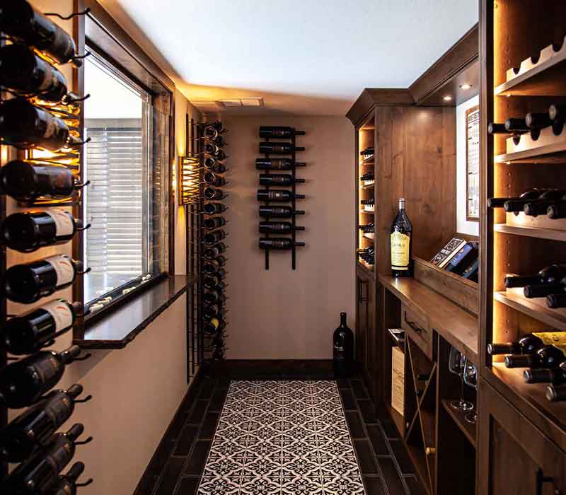This wine cellar features a wine room with temperature and humidity control and custom storage and displays for up to 350 bottles. The adjoining wine tasting room provides space for the homeowners to gather, converse, and celebrate.