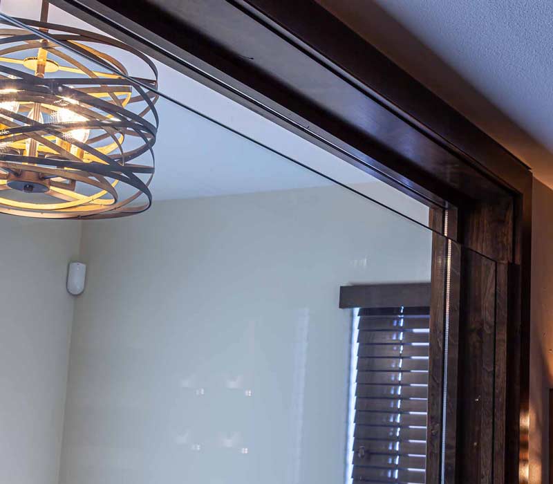 This wine cellar features a wine room with temperature and humidity control and custom storage and displays for up to 350 bottles. The adjoining wine tasting room provides space for the homeowners to gather, converse, and celebrate.