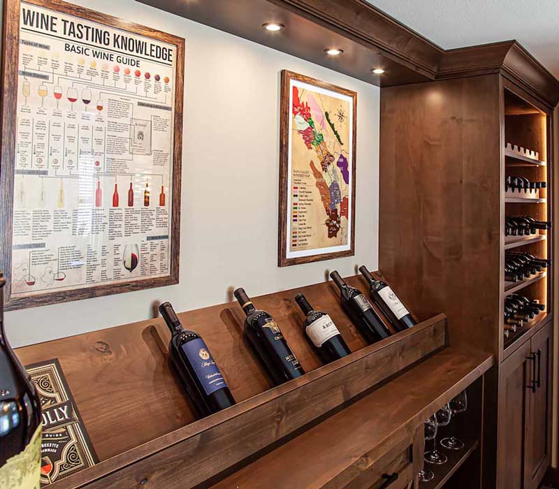 This wine cellar features a wine room with temperature and humidity control and custom storage and displays for up to 350 bottles. The adjoining wine tasting room provides space for the homeowners to gather, converse, and celebrate.
