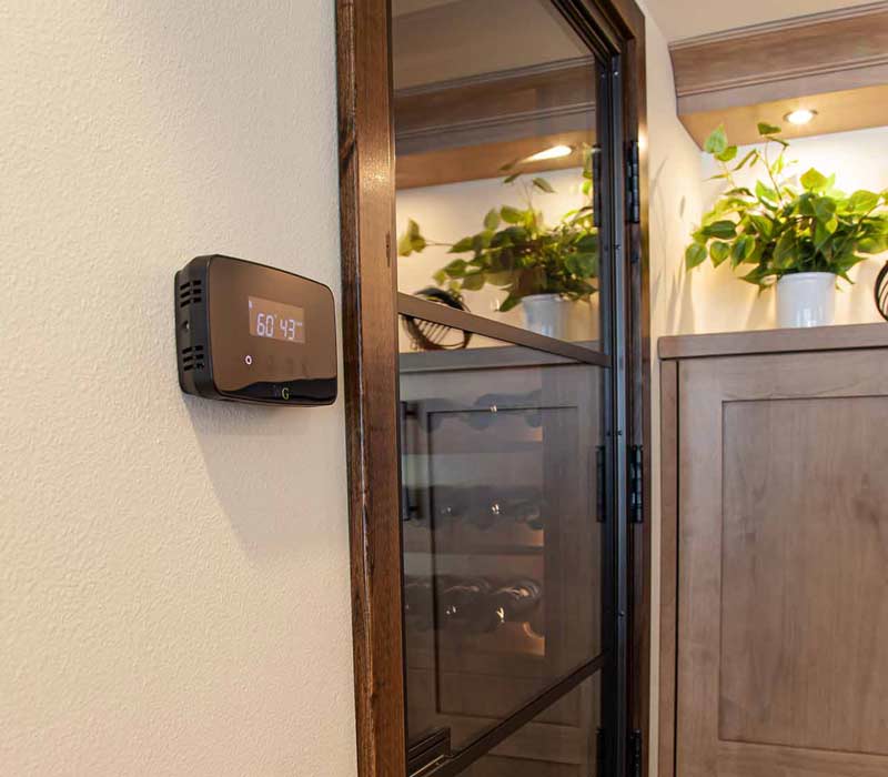 This wine cellar features a wine room with temperature and humidity control and custom storage and displays for up to 350 bottles. The adjoining wine tasting room provides space for the homeowners to gather, converse, and celebrate.