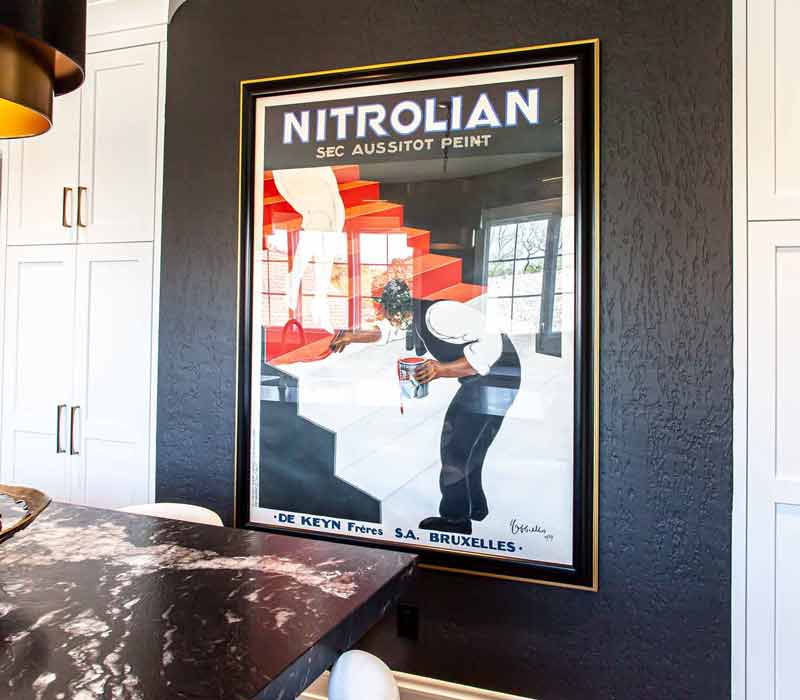 This complete kitchen remodel utilizes timeless materials, an intelligent reconfiguration of the space, and an effortless blend of natural light and warmth. It features cabinetry by DHDK, black quartzite countertops, herringbone wood flooring, a Broan pop-up downdraft hood, and a wet bar.