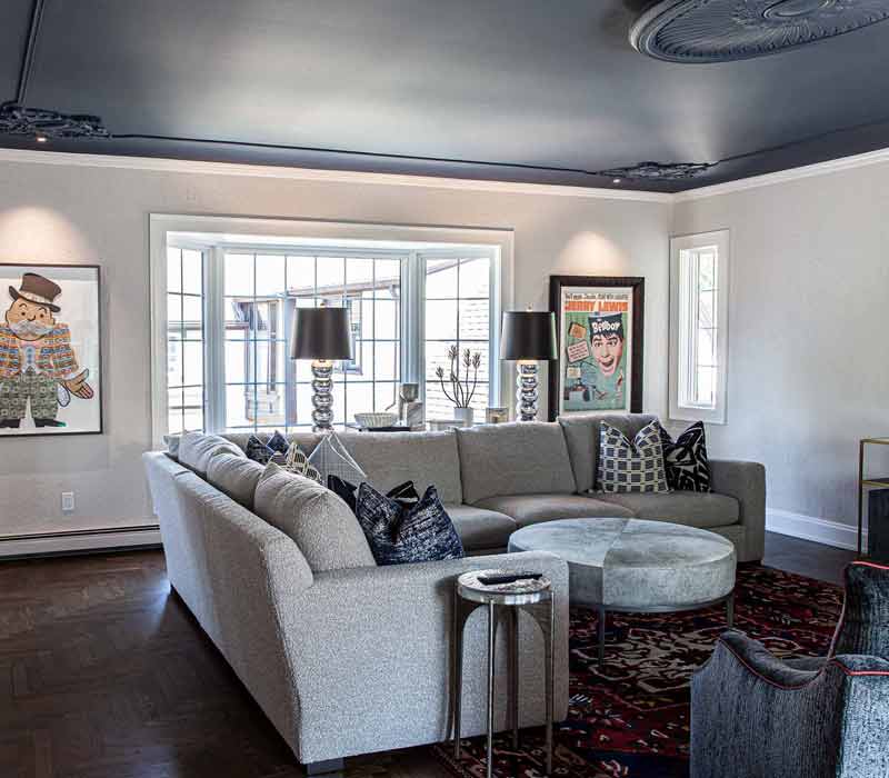 This complete kitchen remodel utilizes timeless materials, an intelligent reconfiguration of the space, and an effortless blend of natural light and warmth. It features cabinetry by DHDK, black quartzite countertops, herringbone wood flooring, a Broan pop-up downdraft hood, and a wet bar.