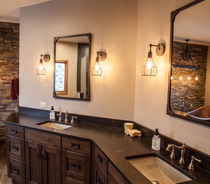 Rustic brick walls, rough-hewn beams, an end-grain cutting board, and a hammered copper sink and range hood add texture to this woodsy open concept kitchen.