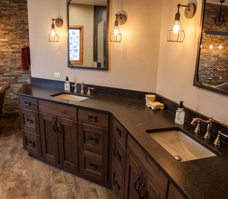 Rustic brick walls, rough-hewn beams, an end-grain cutting board, and a hammered copper sink and range hood add texture to this woodsy open concept kitchen.