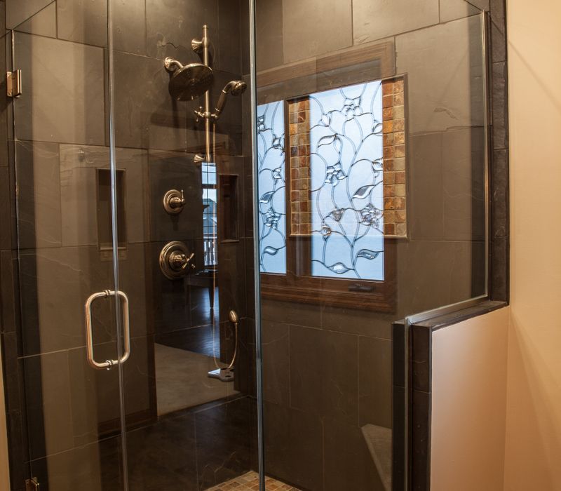 Rustic brick walls, rough-hewn beams, an end-grain cutting board, and a hammered copper sink and range hood add texture to this woodsy open concept kitchen.