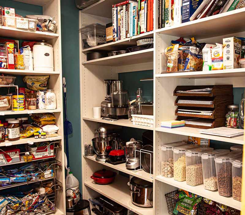 This kitchen remodel celebrates family, nature, and the unique geometry of the original home. It features crisp white cabinetry, cool-toned quartz countertops, two islands, and bold blue accents, plus a tactile mix of materials—wood, metal, glass, and stone—selected to stand the test of time in both durability and style.