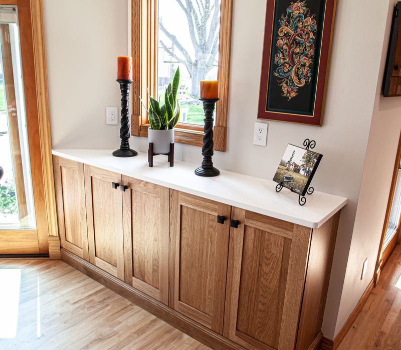 Contemporary black and white geometric accents play off the warm traditional wood cabinetry of this sophisticated kitchen.