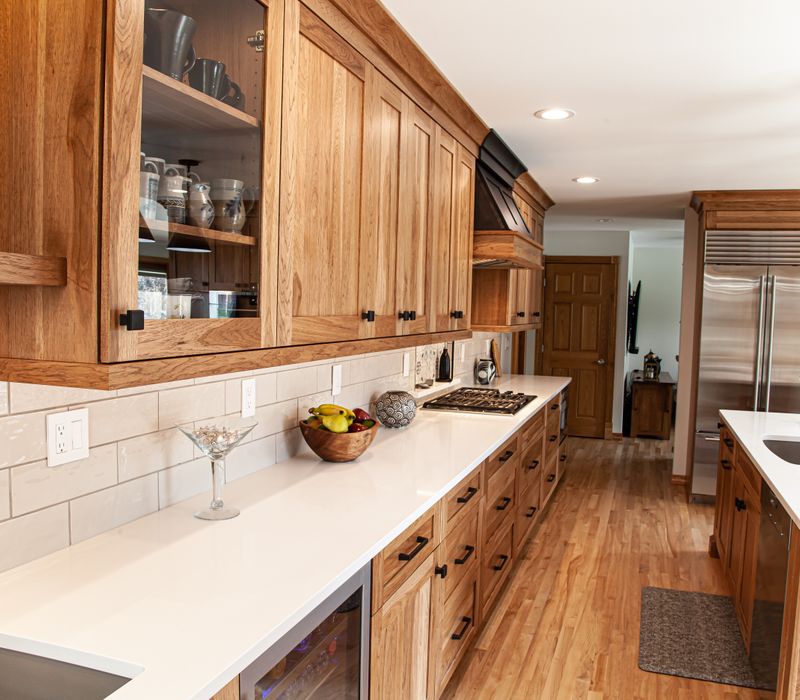 Contemporary black and white geometric accents play off the warm traditional wood cabinetry of this sophisticated kitchen.