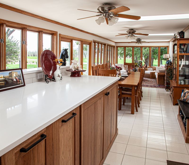 Contemporary black and white geometric accents play off the warm traditional wood cabinetry of this sophisticated kitchen.
