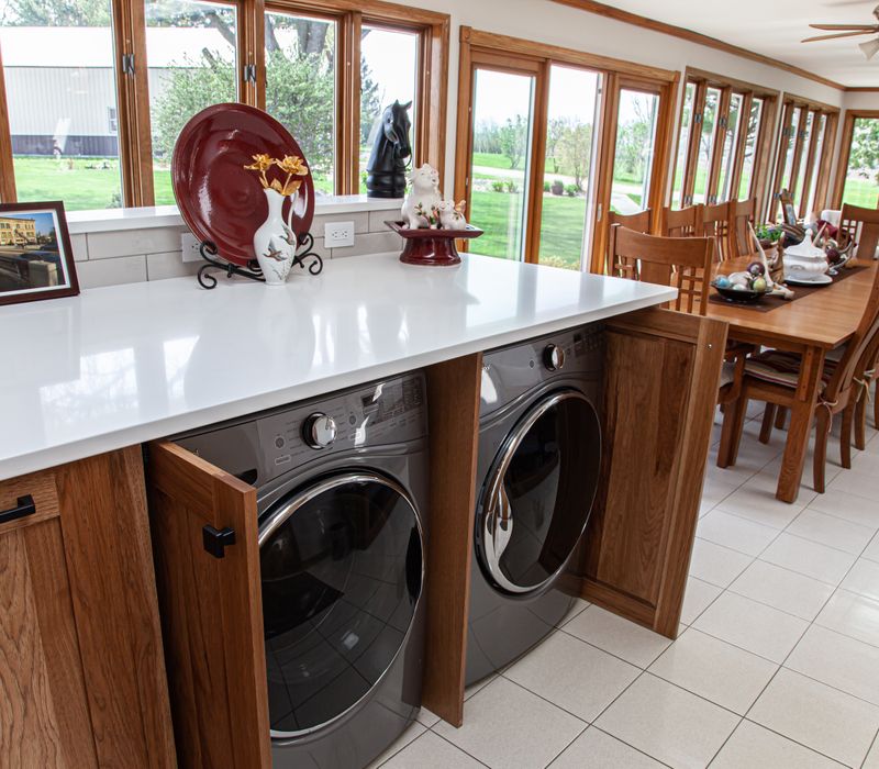 Contemporary black and white geometric accents play off the warm traditional wood cabinetry of this sophisticated kitchen.