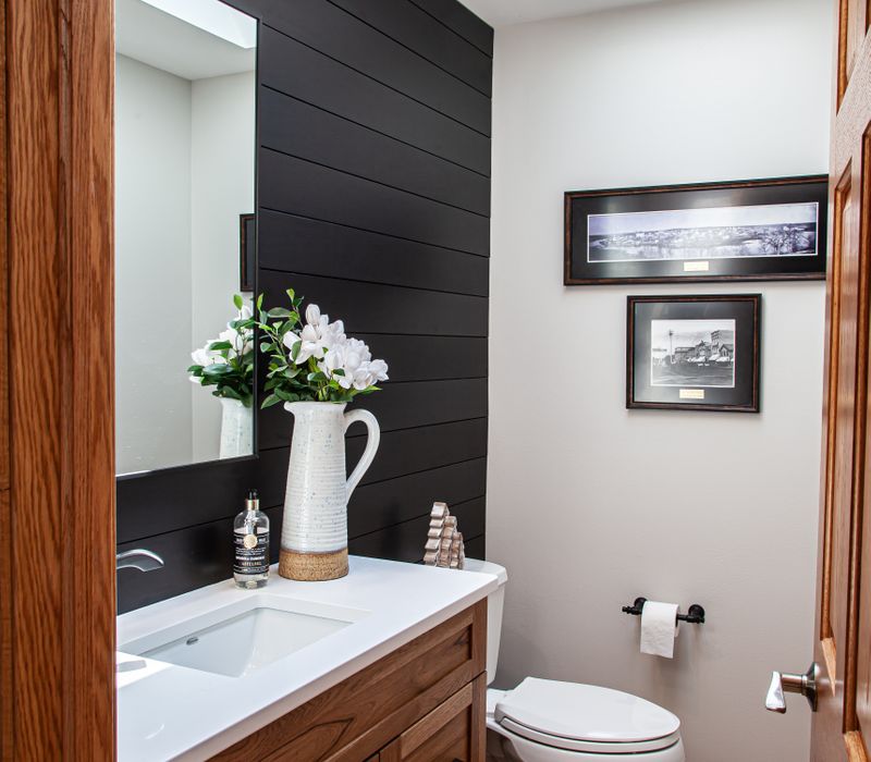 Contemporary black and white geometric accents play off the warm traditional wood cabinetry of this sophisticated kitchen.