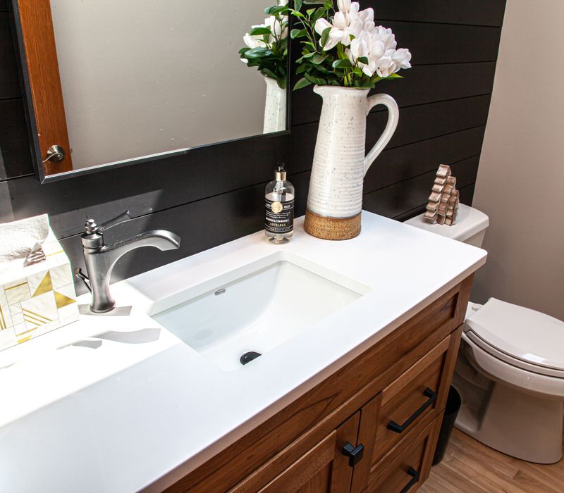 Contemporary black and white geometric accents play off the warm traditional wood cabinetry of this sophisticated kitchen.