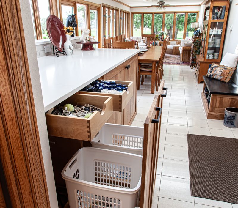 Contemporary black and white geometric accents play off the warm traditional wood cabinetry of this sophisticated kitchen.