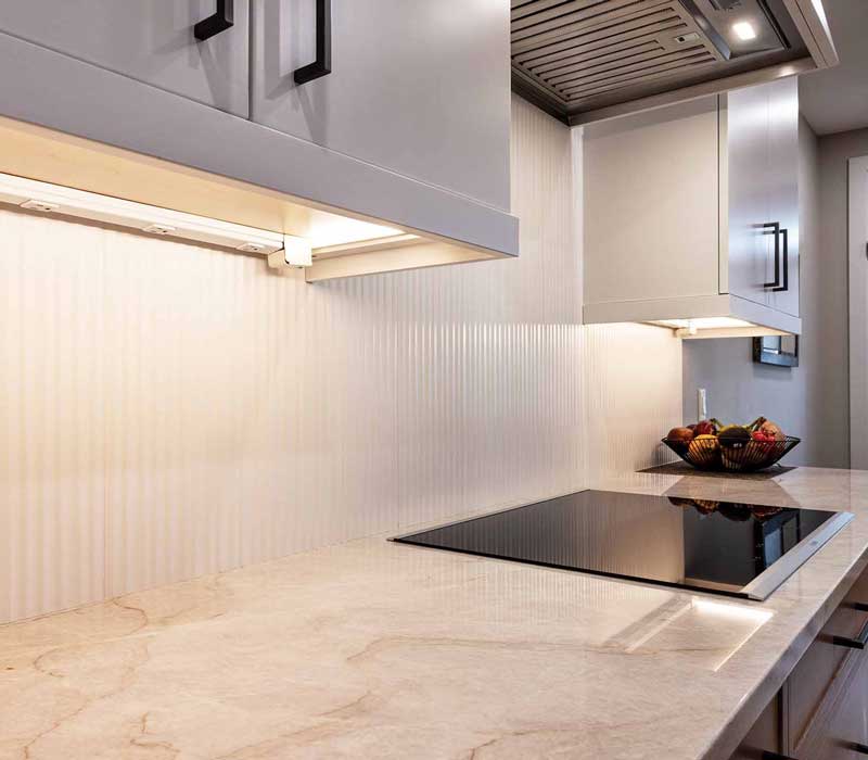 This full kitchen remodel blends natural warmth with refined modernity, crafting a space that is as inviting as it is impeccably tailored. It features custom DHDK cabinetry, Taj Majal quartzite, Bosch stainless steel appliances, and intuitive storage options.