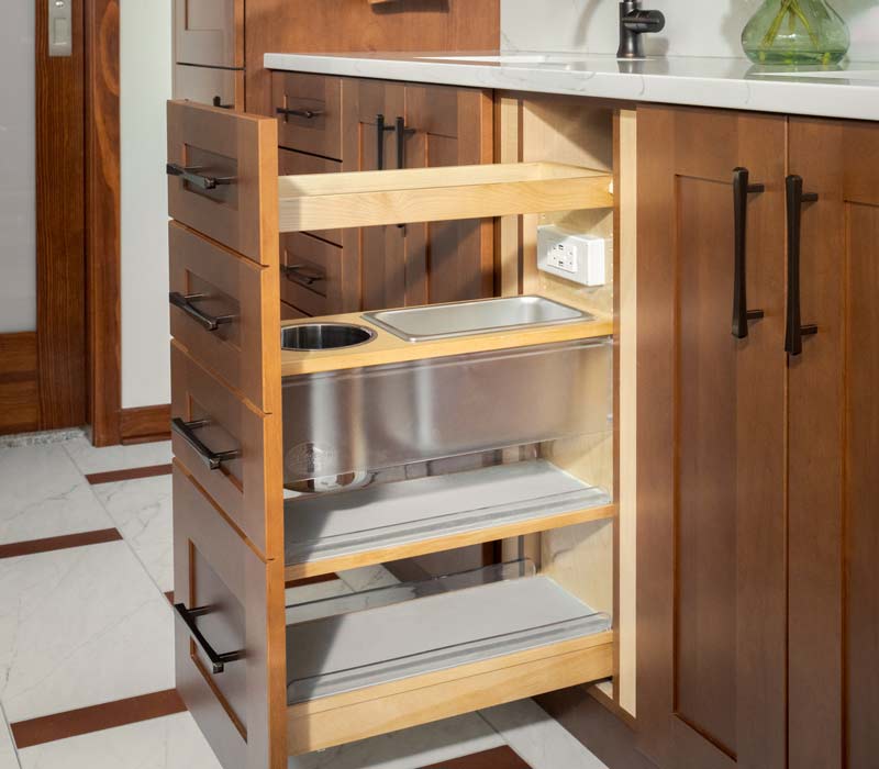 This whole-house remodel features a prairie-style kitchen adorned with custom cabinetry by DHDK, a primary suite with custom alder armoire, and bathroom with iridescent blue-green tiles.
