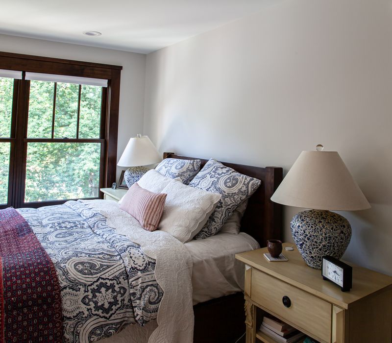 Dark woodwork, patterned terra cotta tile floors, and exposed brick interior walls define the kitchen and addition of this Craftsman home.