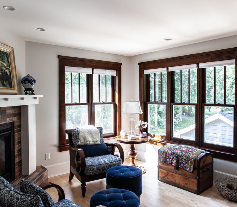 Dark woodwork, patterned terra cotta tile floors, and exposed brick interior walls define the kitchen and addition of this Craftsman home.