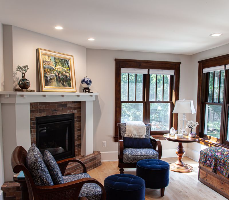 Dark woodwork, patterned terra cotta tile floors, and exposed brick interior walls define the kitchen and addition of this Craftsman home.