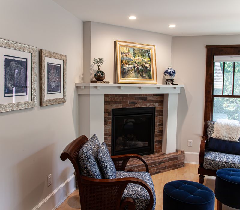 Dark woodwork, patterned terra cotta tile floors, and exposed brick interior walls define the kitchen and addition of this Craftsman home.