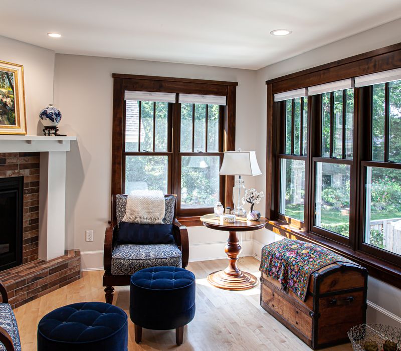 Dark woodwork, patterned terra cotta tile floors, and exposed brick interior walls define the kitchen and addition of this Craftsman home.