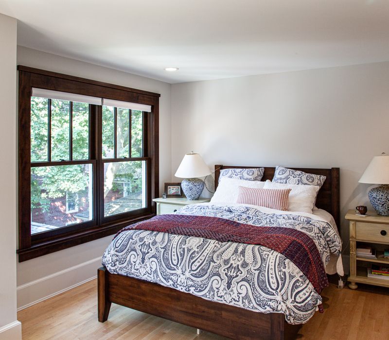 Dark woodwork, patterned terra cotta tile floors, and exposed brick interior walls define the kitchen and addition of this Craftsman home.
