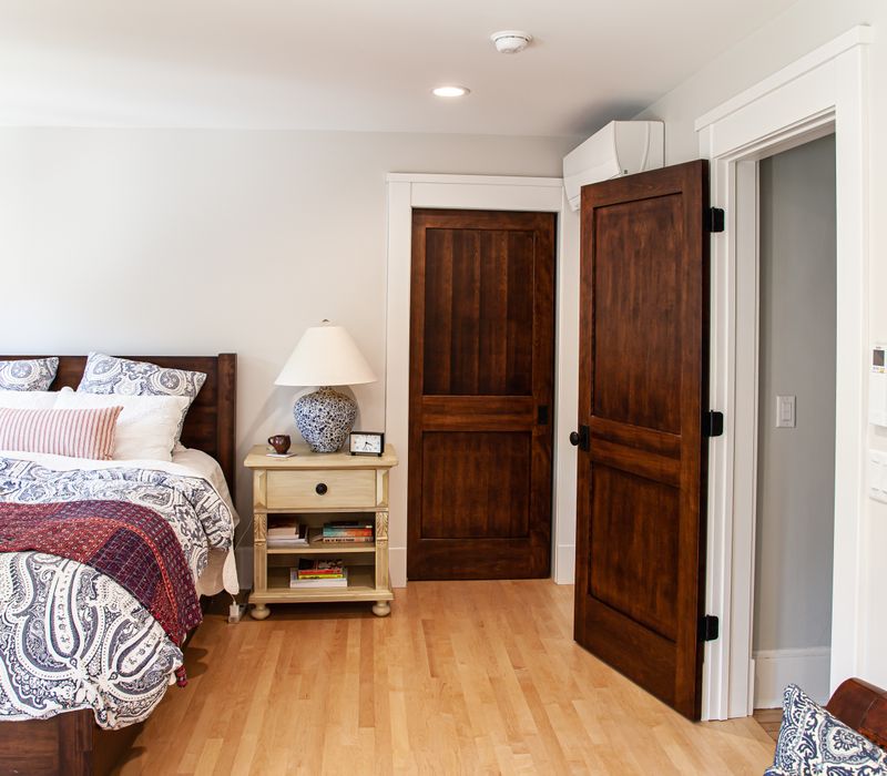 Dark woodwork, patterned terra cotta tile floors, and exposed brick interior walls define the kitchen and addition of this Craftsman home.