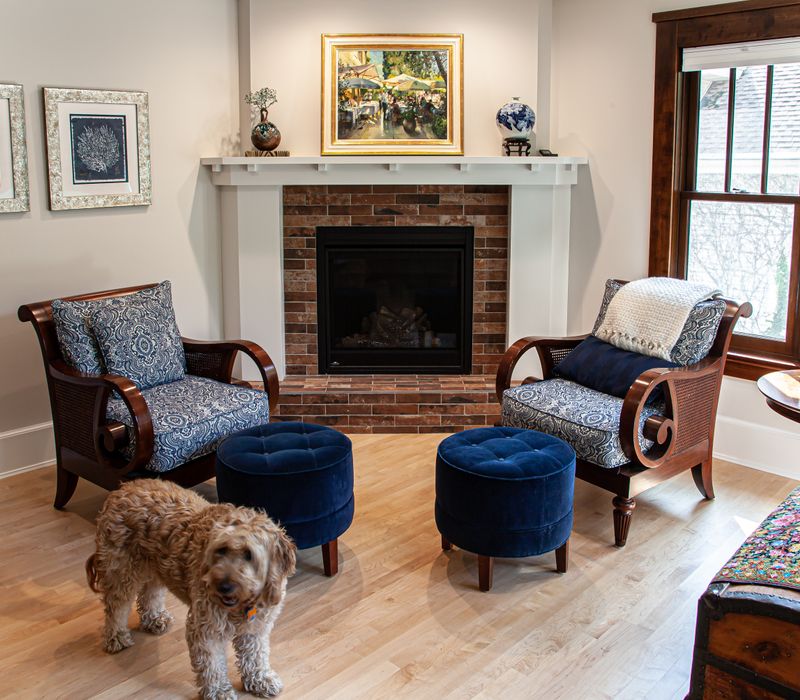 Dark woodwork, patterned terra cotta tile floors, and exposed brick interior walls define the kitchen and addition of this Craftsman home.