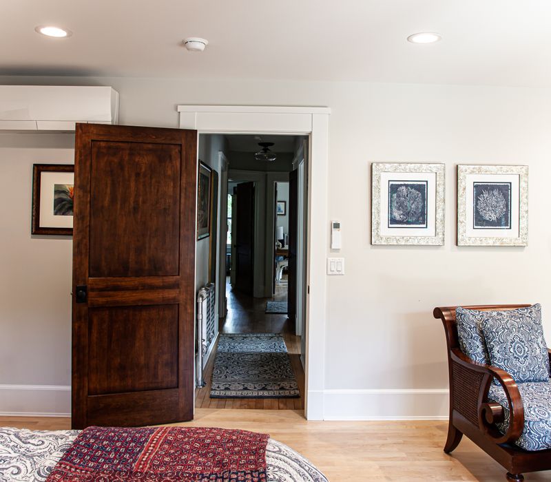 Dark woodwork, patterned terra cotta tile floors, and exposed brick interior walls define the kitchen and addition of this Craftsman home.