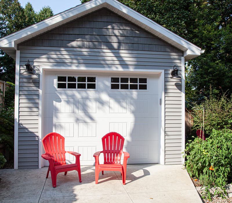 Dark woodwork, patterned terra cotta tile floors, and exposed brick interior walls define the kitchen and addition of this Craftsman home.
