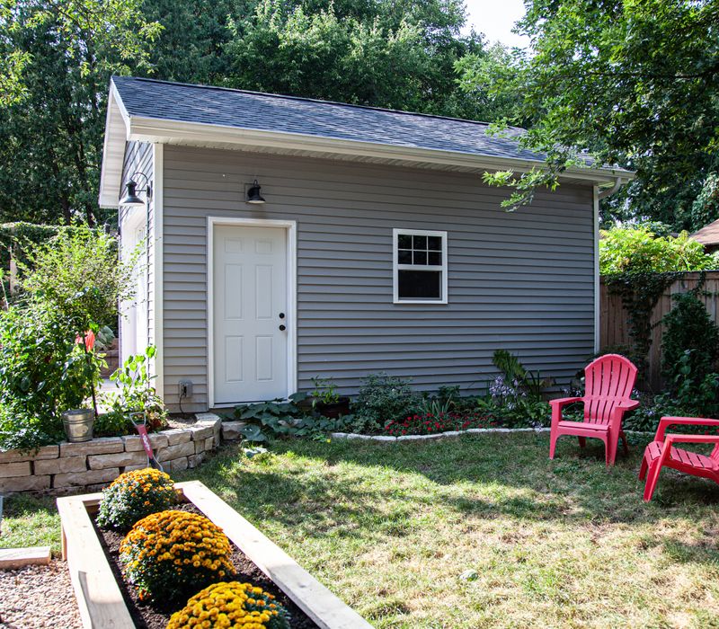 Dark woodwork, patterned terra cotta tile floors, and exposed brick interior walls define the kitchen and addition of this Craftsman home.