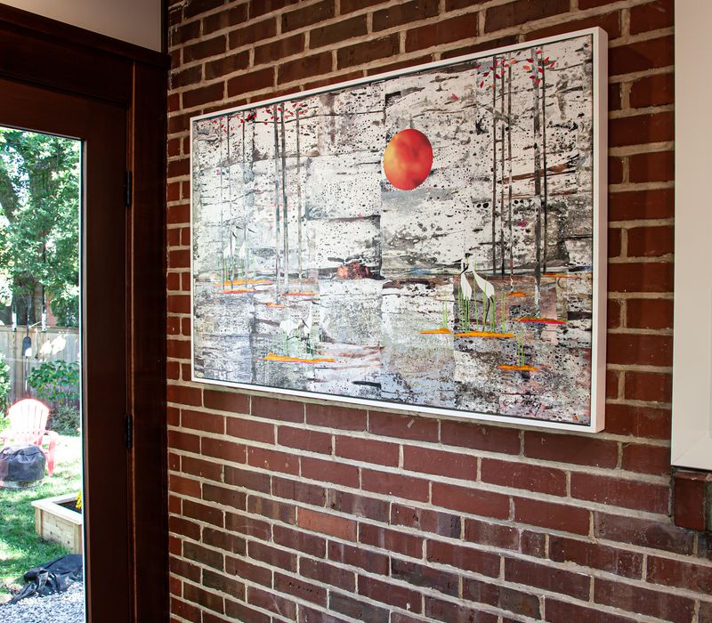 Dark woodwork, patterned terra cotta tile floors, and exposed brick interior walls define the kitchen and addition of this Craftsman home.