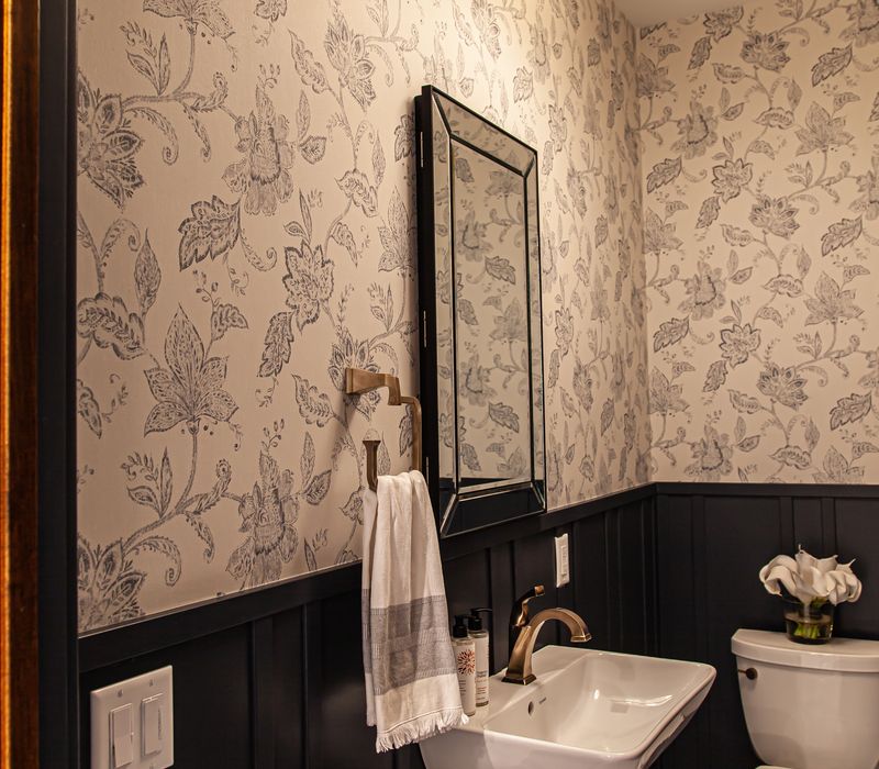 Dark woodwork, patterned terra cotta tile floors, and exposed brick interior walls define the kitchen and addition of this Craftsman home.