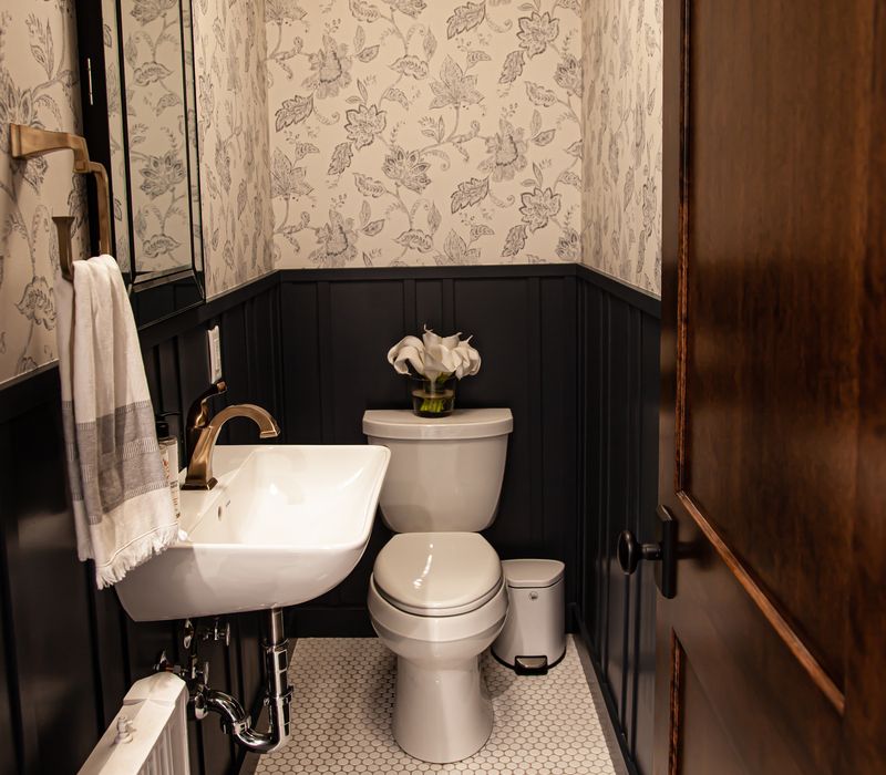 Dark woodwork, patterned terra cotta tile floors, and exposed brick interior walls define the kitchen and addition of this Craftsman home.