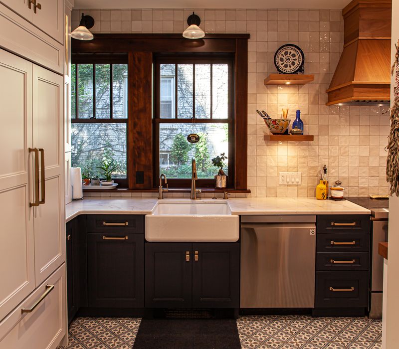Dark woodwork, patterned terra cotta tile floors, and exposed brick interior walls define the kitchen and addition of this Craftsman home.