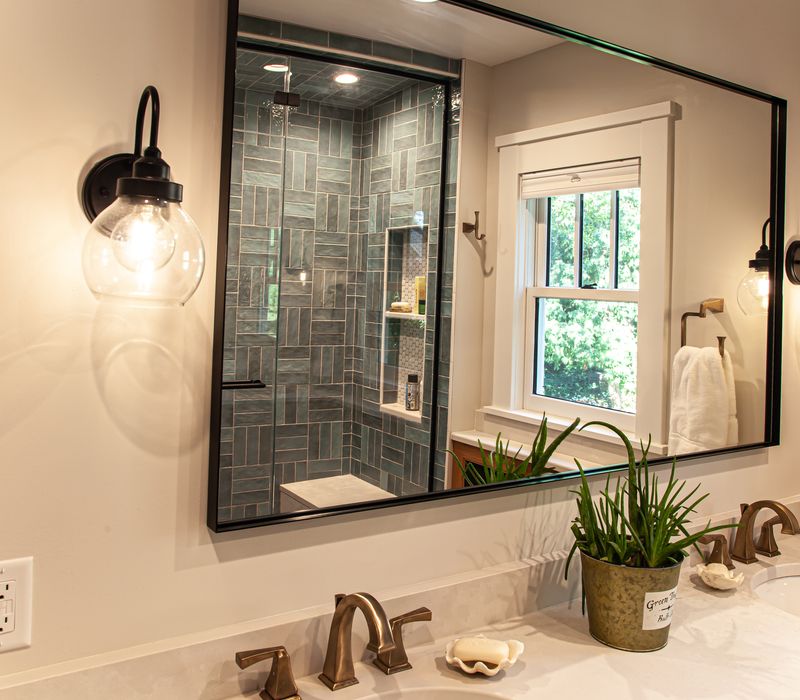 Dark woodwork, patterned terra cotta tile floors, and exposed brick interior walls define the kitchen and addition of this Craftsman home.