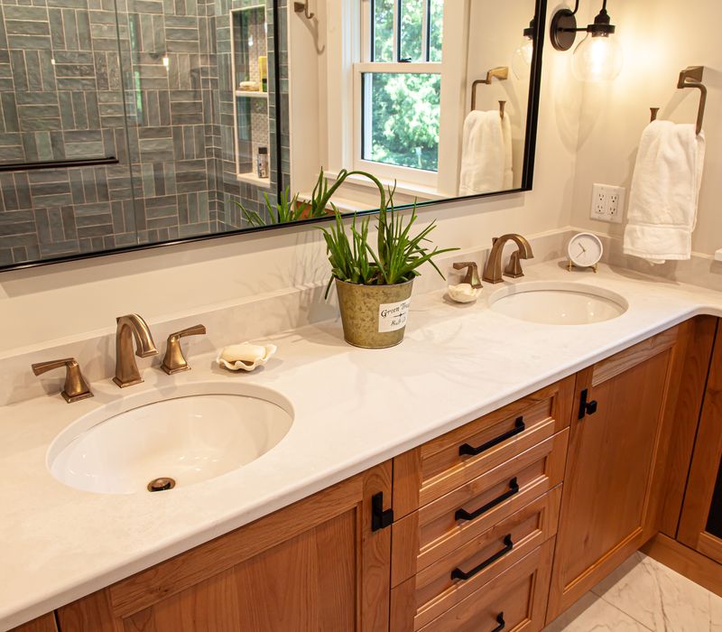 Dark woodwork, patterned terra cotta tile floors, and exposed brick interior walls define the kitchen and addition of this Craftsman home.